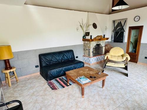 a living room with a couch and a fireplace at Casa Uliveto in Diano San Pietro