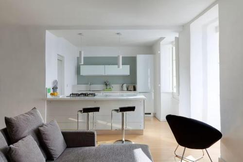 a living room with a couch and a kitchen at Valletta Seafront in Valletta