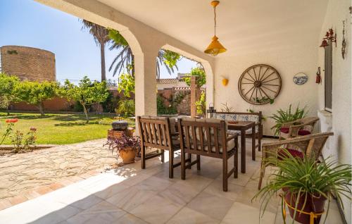 a patio with a table and chairs on a patio at Stunning Home In Conil De La Frontera in Conil de la Frontera