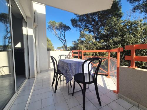 une table et des chaises sur le balcon d'une maison dans l'établissement Le Quercus appartement 2,4 personnes proche mer, à Saint-Raphaël