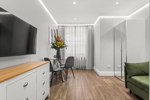 a living room with a tv and a couch at Cleveland Residences Russell Square in London