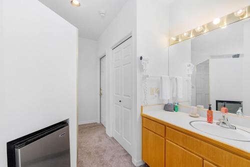 a bathroom with a sink and a large mirror at Alpine Studio at Mount Bachelor Village Resort with Pool and Hot Tub in Bend