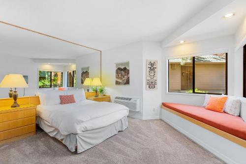 a white bedroom with two beds and a window at Alpine Studio at Mount Bachelor Village Resort with Pool and Hot Tub in Bend