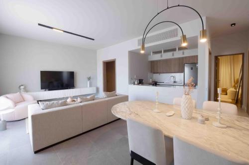 a kitchen and living room with a table and a couch at El Gouna - BIRD NEST in Hurghada