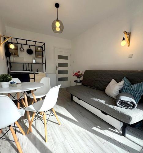 a living room with a couch and a table at Perła in Stegna