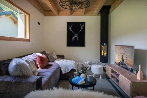 a living room with a couch and a table at Chalet Ormiages - OVO Network in Saint-Gervais-les-Bains