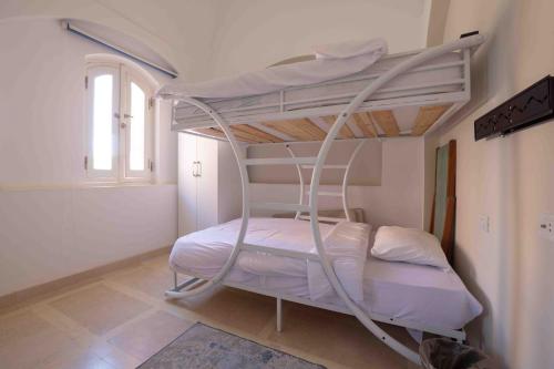 a bedroom with a bunk bed with a ladder at El Gouna - BIRD NEST in Hurghada