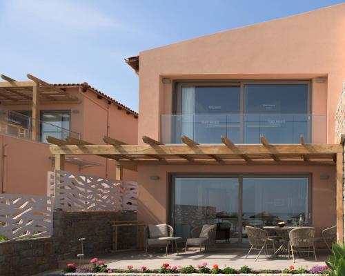 a house with a pergola and a patio at High Beach Resort in Malia