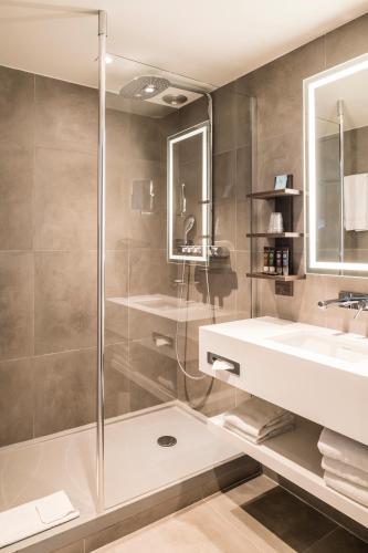 a bathroom with a shower and a sink at Novotel Paris Les Halles in Paris