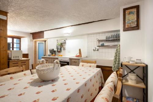 a kitchen with a table with a bowl on it at Chalet Case delle lobbie in Ceppo Morelli