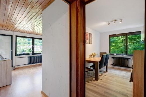 an open kitchen and dining room with a table and windows at Ferienwohnung Am Lehen Schiltach in Schiltach