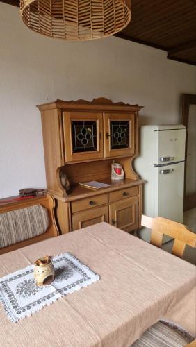 a kitchen with a table and a refrigerator at Sunny&Cozy - Maisonette Apartment in See Nähe in Sankt Urban