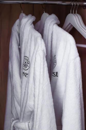 a group of white towels hanging on a rack at Forest Retreat Center in Kyiv