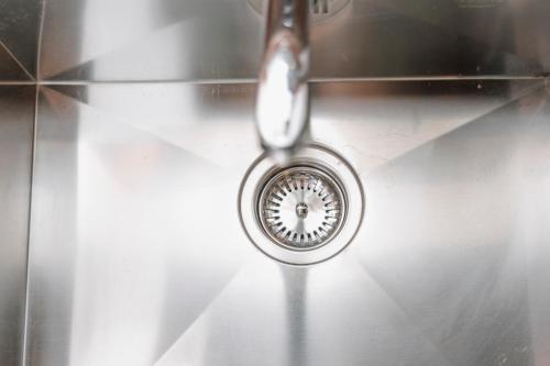a sink with a drain in the middle of it at CONVIVIUM - Suites Apartments in Randazzo