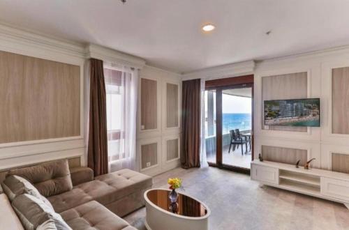 a large living room with a couch and a table at Green Stone Apartments in Rafailovici