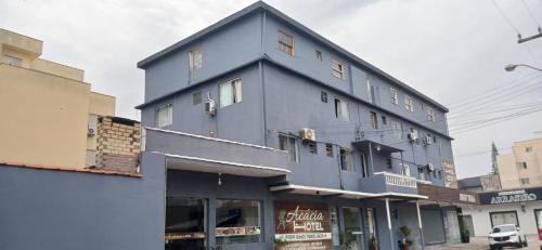 a blue building with windows on a street at Acacia hotel in Laguna