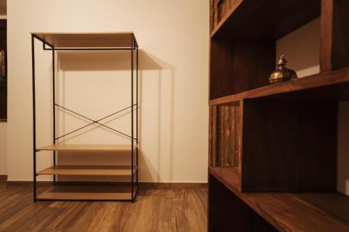 a glass cabinet in a room with wooden floors at CONVIVIUM - Suites Apartments in Randazzo