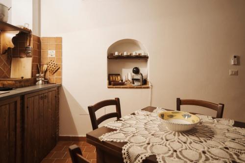 a kitchen with a table with a bowl on it at CONVIVIUM - Suites Apartments in Randazzo