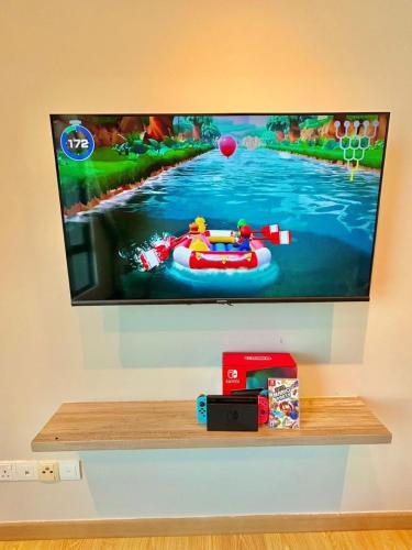 a flat screen tv hanging on a wall at imperium residence kuantan in Kuantan