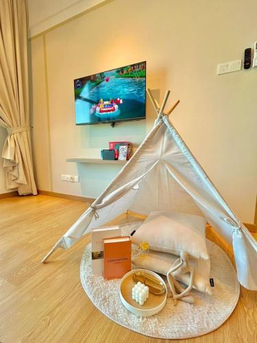 a room with a bed with a tent and some boxes at imperium residence kuantan in Kuantan