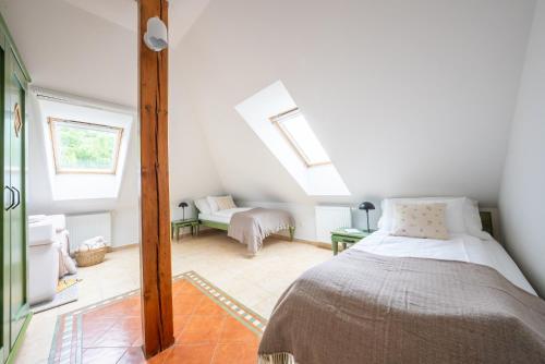 a bedroom with a bed and a couch in a attic at penzion Dvorce in Třeboň