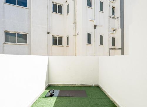 a room with a yoga mat in front of a building at Large Studio Penthouse with 2 terraces - By Solea Holiday Homes in Il-Gżira