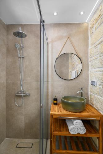 a bathroom with a sink and a shower at Avgi in Pitsidia
