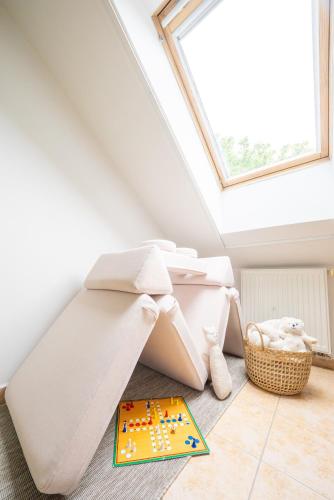 a bed in a room with a window at penzion Dvorce in Třeboň
