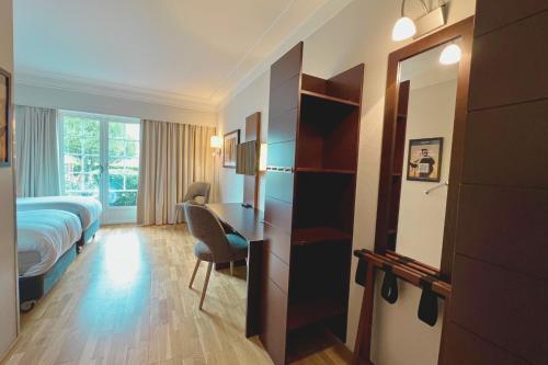 a hotel room with a bed and a desk at Havna Tjøme Hotel in Tjøme
