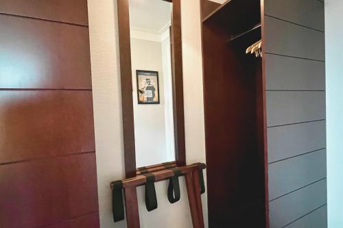 a hallway with a door and a mirror at Havna Tjøme Hotel in Tjøme