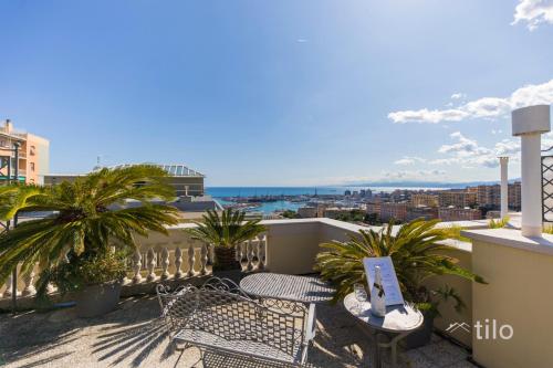 a balcony with two chairs and a view of the ocean at JACUZZI| TERRACE| 2BR| ART GALLERY| By Tilo Lux in Genova