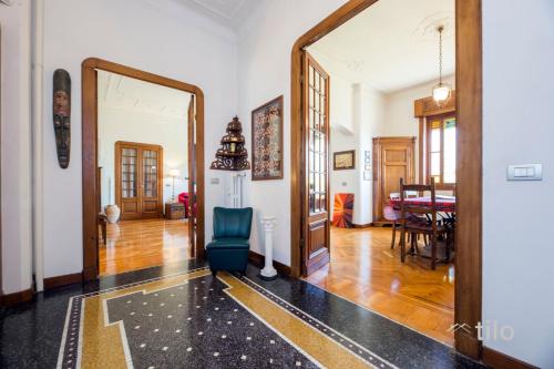 a living room with a mirror and a blue chair at JACUZZI| TERRACE| 2BR| ART GALLERY| By Tilo Lux in Genova