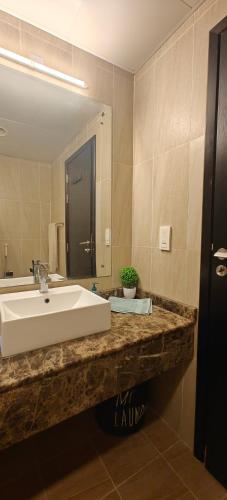 a bathroom with a sink and a large mirror at JLT 1BR Marina Skyline View in Dubai