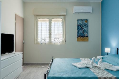 Ένα ή περισσότερα κρεβάτια σε δωμάτιο στο La Conchiglia