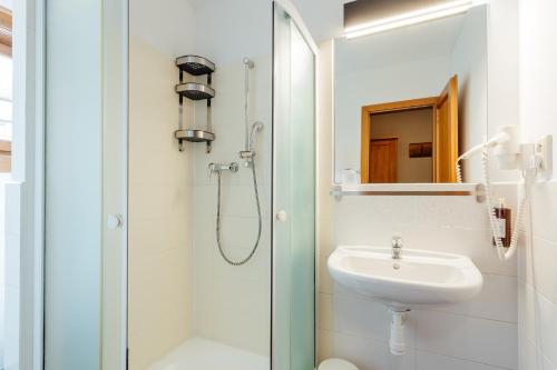 a bathroom with a sink and a shower at Resort Drevenice Terchova in Terchová