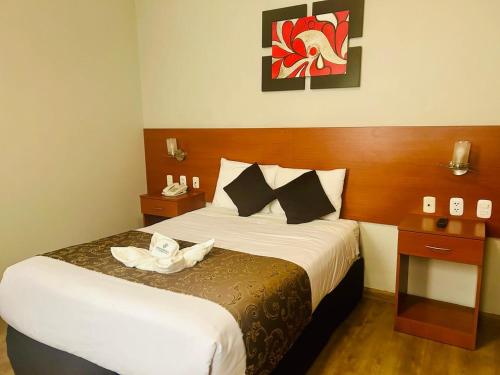 a hotel room with a bed with a towel on it at Casona Plaza Hotel Colonial in Arequipa