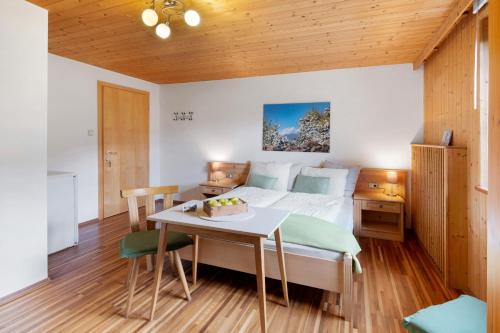 a bedroom with a bed and a table at Bauernhof Sackgut in Ciardes