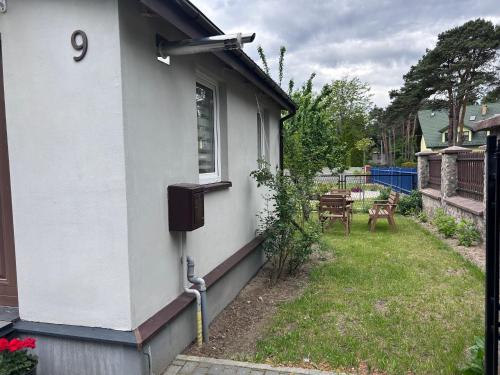 a white house with a window and a yard at Pod LIPÓWKAMI in Olsztyn