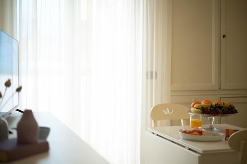 a kitchen with a bowl of fruit on a table at Hotel Mondial in Bellaria-Igea Marina