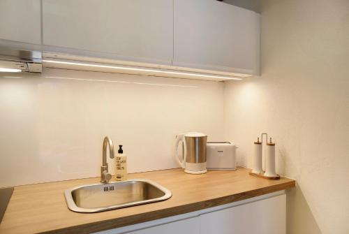 a kitchen counter with a sink and a microwave at Suite Home Seefeld in Seefeld in Tirol