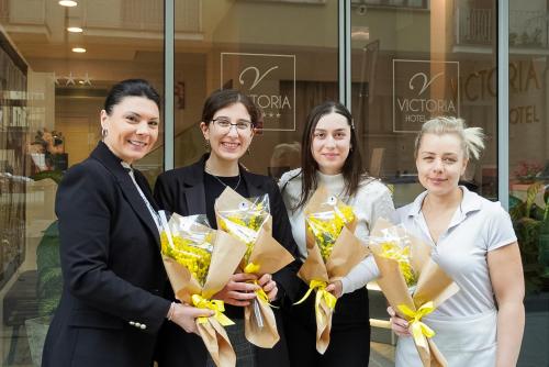 a group of women standing in front of a store at Hotel Victoria in Cuneo