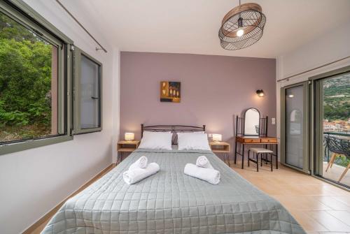 a bedroom with a bed with two towels on it at Casa Mare2 in Ayia Evfimia