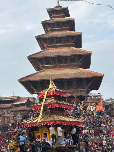 a crowd of people standing in front of a pagoda at HOTEL RUPAKOT AND ROOFTOP RESTAURANT in Bhaktapur