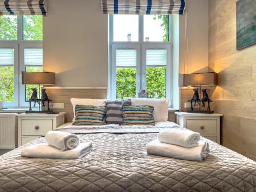 a bedroom with a large bed with two pillows at Willa Błękit Hotel by Dorota Szelągowska in Mielno