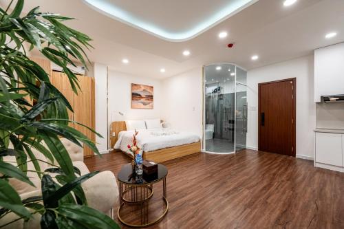 a bedroom with a bed and a glass door at A Boi Apartment at District 3 in Ho Chi Minh City