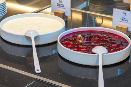 two spoons sitting on top of a counter with a pie at Holiday Inn Express London - Epsom Downs by IHG in Epsom