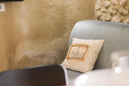 a pillow sitting on a couch next to a wall at Casa Luxury Grotta - Bagno Hammam in Santo Stefano di Sessanio