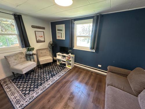 a living room with two chairs and a couch at Cabin Getaway with Lake View! in Coeur d'Alene