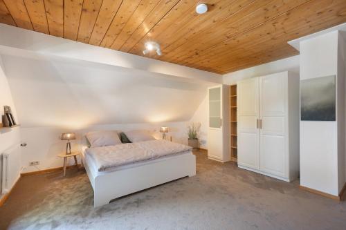 a bedroom with a bed and a wooden ceiling at Ferienhaus Rotkreuz in Haslach im Kinzigtal
