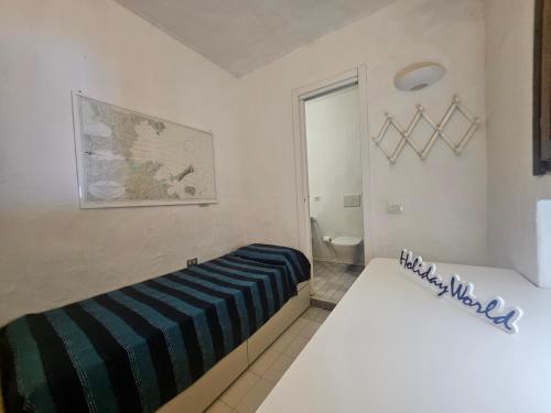 Ένα ή περισσότερα κρεβάτια σε δωμάτιο στο Villaggio Est by Holiday World